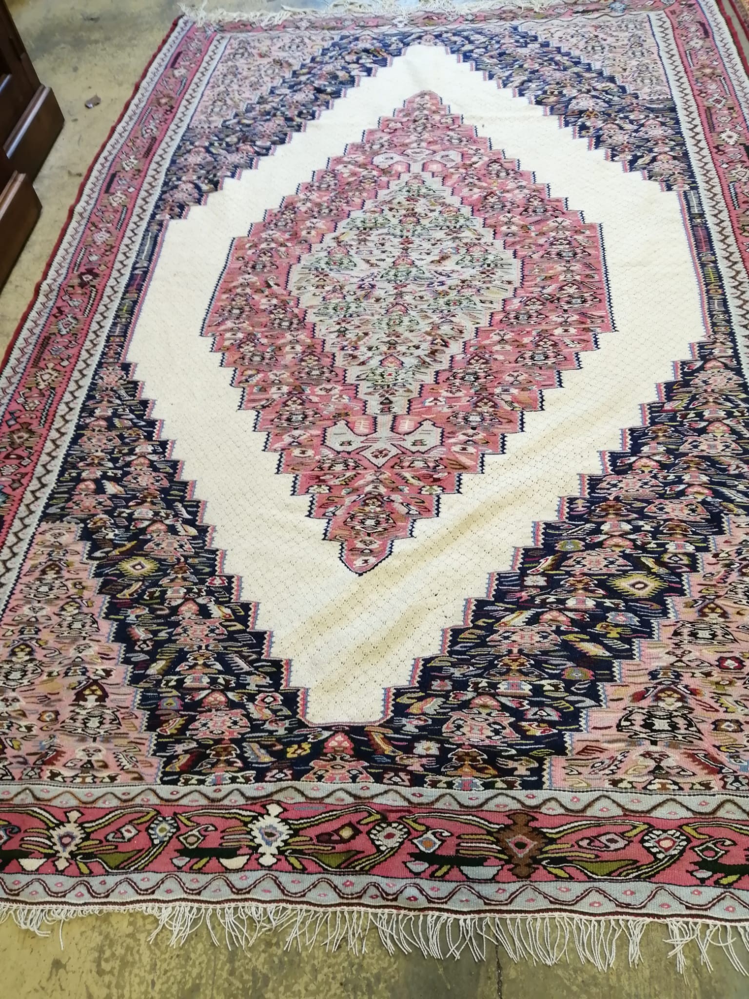 A Senneh ivory ground flat weave carpet, 280 x 190cm